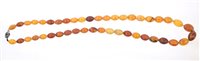 Lot 762 - Amber bead necklace with graduated amber beads,...