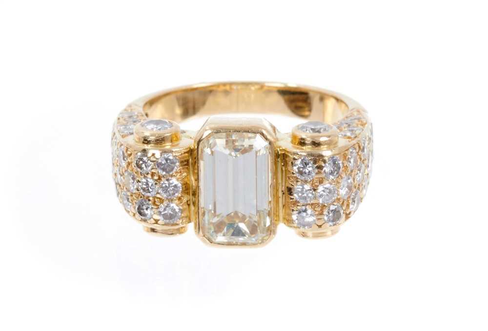 Lot 406 - Art Deco-style diamond dress ring, the principal emerald cut diamond measuring approximately 9.80mm x 5.50mm x 4.41mm, estimated to weigh approximately 2.51 carats, in a yellow gold rub-over settin...