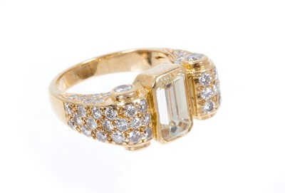 Lot 406 - Art Deco-style diamond dress ring, the principal emerald cut diamond measuring approximately 9.80mm x 5.50mm x 4.41mm, estimated to weigh approximately 2.51 carats, in a yellow gold rub-over settin...