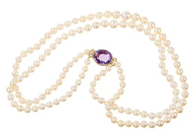 Lot 487 - Cultured pearl two-strand necklace with an amethyst clasp