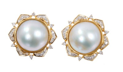 Lot 414 - Pair of Mabe pearl and diamond earrings, each with a large cultured Mabe pearl measuring approximately 16mm diameter in 18ct gold setting with stylised petals set with brilliant cut diamonds, the b...