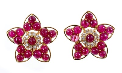 Lot 408 - Pair of ruby and diamond flower head cluster earrrings, each with cabochon rubies and brilliant cut diamonds in 18ct gold setting with clip fittings. 28mm