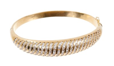 Lot 410 - 18ct gold and diamond hinged bangle