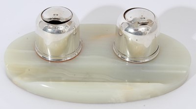 Lot 215 - George V silver and alabaster ink stand of oval form, with integral pen rest and two silver ink pots with domed sliding covers and removable inkwells to interiors, (Birmingham 1923), Maker Mappin &...