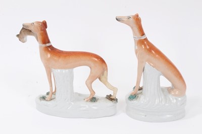 Lot 24 - Two Victorian Staffordshire figures of greyhounds, the largest measuring 21cm height