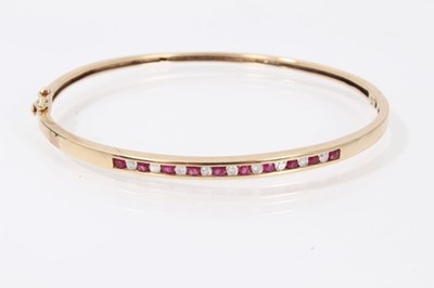 Lot 529 - 9ct gold ruby and diamond hinged bangle