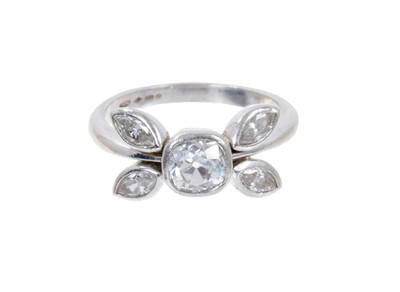 Lot 423 - Diamond cluster ring of stylised floral design, the central old cut diamond estimated to weigh approximately 0.75 carats flanked by four marquise cut diamonds, all in platinum collet setting on pla...