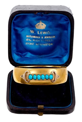 Lot 422 - Victorian gold hinged bangle with a line of six turquoise cabochons and two small diamonds to the buckle terminals, in fitted box