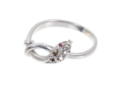 Lot 424 - Antique diamond and platinum snake ring with six pavé  set old cut diamonds and ruby eyes. Ring size G