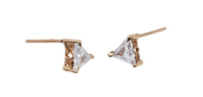 Lot 419 - Pair of diamond single stone earrings with a triangular cut diamond in gold claw setting. Estimated total diamond weight approximately 0.50 carats