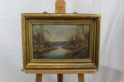 Lot 1192 - Nils Hans Christiansen pair of oils - river landscapes, in gilt frames