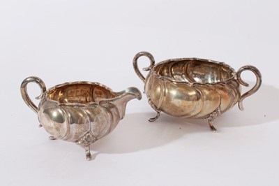 Lot 226 - Early 20th Century Danish silver sugar bowl and milk jug, with wrythen decoration and scroll handles, raised on scroll feet, marked for Copenhagen and also Christian F. Heise (Circa. 1904 - 32) and...