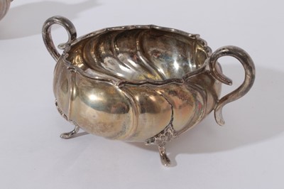 Lot 226 - Early 20th Century Danish silver sugar bowl and milk jug, with wrythen decoration and scroll handles, raised on scroll feet, marked for Copenhagen and also Christian F. Heise (Circa. 1904 - 32) and...