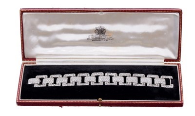 Lot 436 - Art Deco-style diamond bracelet with ten rectangular openwork panels of pavé set brilliant cut diamonds, each articulated panel joined by ten further pavé set diamond plaques, all in millegrain set...