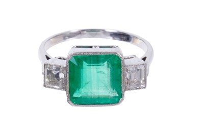 Lot 483 - Art Deco style emerald and diamond three stone ring with a square step cut emerald weighing approximately 2.42 carats flanked by two step cut diamonds weighing 0.50 carats in total, all in millegra...