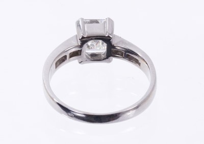 Lot 484 - Diamond single stone ring with a step cut diamond weighing approximately 1.23 carats in four claw setting with further step cut diamonds to the shoulders. Ring size L.