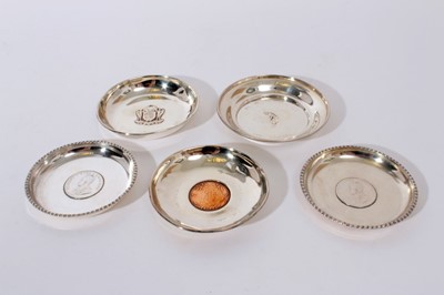 Lot 248 - George VI silver pin dish of circular form, with embossed decoration 'The Daily Telegraph and Morning Post Tournament for Lady Golfers' (Londond 1938), together with another set with a coin and eng...