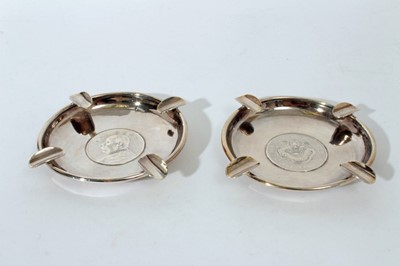 Lot 250 - Pair of Chinese silver ashtrays of circular form set with coins, marked Y C Levy, Sterling, all at approximately 5oz, 11.3cm in diameter
