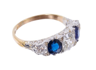 Lot 499 - Late Victorian diamond and sapphire five stone ring with three old cut diamonds interspaced by two oval mixed cut blue sapphires in carved scroll settting with rose cut diamond cents to the claws o...