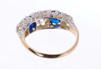 Lot 499 - Late Victorian diamond and sapphire five stone ring with three old cut diamonds interspaced by two oval mixed cut blue sapphires in carved scroll settting with rose cut diamond cents to the claws o...