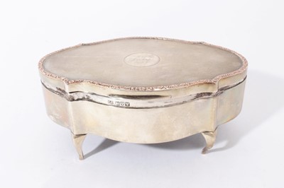 Lot 275 - George V silver jewellery box of oval form with engine turned decoration and decorative scroll borders, raised on cabriole legs, (Chester 1921), Maker, Charles Cooke, 14.5cm in overall length