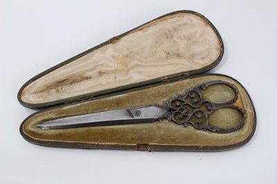 Lot 750 - Pair of late 19th century cut steel scissors in leather case