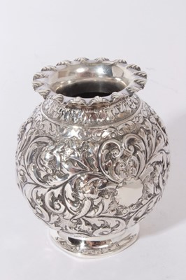 Lot 317 - Victorian silver vase of globular form with ornate embossed foliate and scroll decoration, on flared foot, (London 1891), maker Horace Woodward & Co, all at 5oz, 11cm in overall height