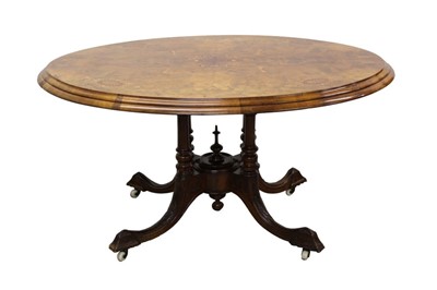 Lot 1356 - Victorian figured walnut and marquetry inlaid oval breakfast table, the geometric inlaid tilt top on turned column supports and splayed quadruped base with castors, 128 x 94cm