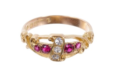 Lot 545 - Edwardian ruby and diamond ring with a scroll of three old cut diamonds flanked by four mixed-cut rubies, carved gold scroll shoulders on plain shank, Birmingham 1904, ring size L½