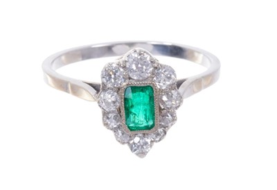 Lot 547 - Emerald and diamond pear-shape cluster ring with a central mixed cut emerald surrounded by a border of old cut diamonds with pierced gallery on plain shank. Ring size N½.