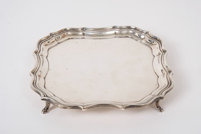 Lot 371 - Georgian style silver card tray raised on four feet , (London 1915) 6 ozs