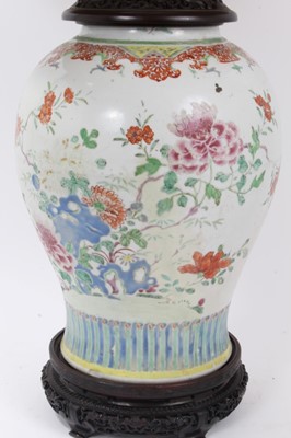 Lot 161 - Large 18th/19th century Chinese famille rose porcelain baluster jar, painted with peonies and other flowers, converted to a vase with fine quality carved hardwood stand and lid, the jar measuring 3...