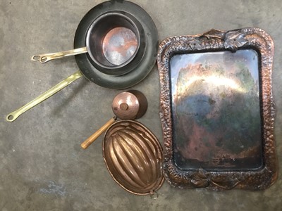 Lot 139 - Arts and crafts beaten copper twin handled tray together with copper pans and a jelly mould