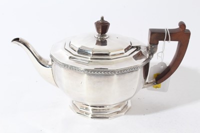 Lot 43 - George V silver teapot of cauldron form with faceted decoration, bakelite finial and angular handle