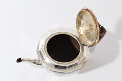 Lot 43 - George V silver teapot of cauldron form with faceted decoration, bakelite finial and angular handle