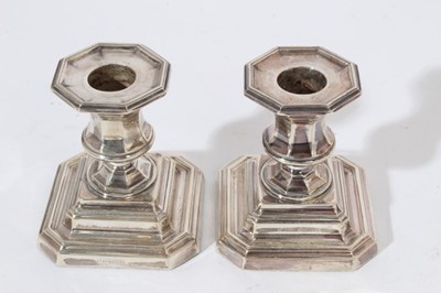 Lot 236 - Pair of Edwardian dwarf candlesticks on stepped square bases with urn shaped candle holders, (Sheffield 1908), maker James Dixon & Sons, approximately 8.5cm in overall height