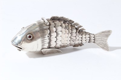 Lot 237 - Late 19th century German Hanau silver articulated model of a fish, with engraved decoration on body and tail, set with two red gem stones for eyes, hinged mouth and head