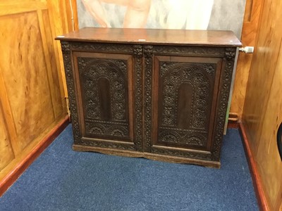 Lot 1397 - Late Victorian carved oak cupboard with two doors decorated with arched floral horses and human masks enclosing adjustable shelves, 108cm wide, 85cm high, 46cm deep