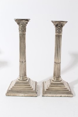 Lot 17 - Pair of Victorian silver Corinthian column candlesticks with fluted columns, candle holders with acanthus leaf decoration, separate sconces with beaded borders