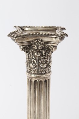 Lot 17 - Pair of Victorian silver Corinthian column candlesticks with fluted columns, candle holders with acanthus leaf decoration, separate sconces with beaded borders