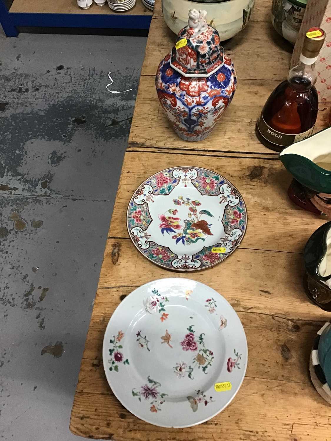 Lot 10 - Two 18th century Chinese export porcelain plates together with a 19th century Japanese Imari vase and cover (3)