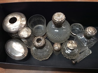 Lot 704 - Group of silver topped vanity jars, scent bottles and other items