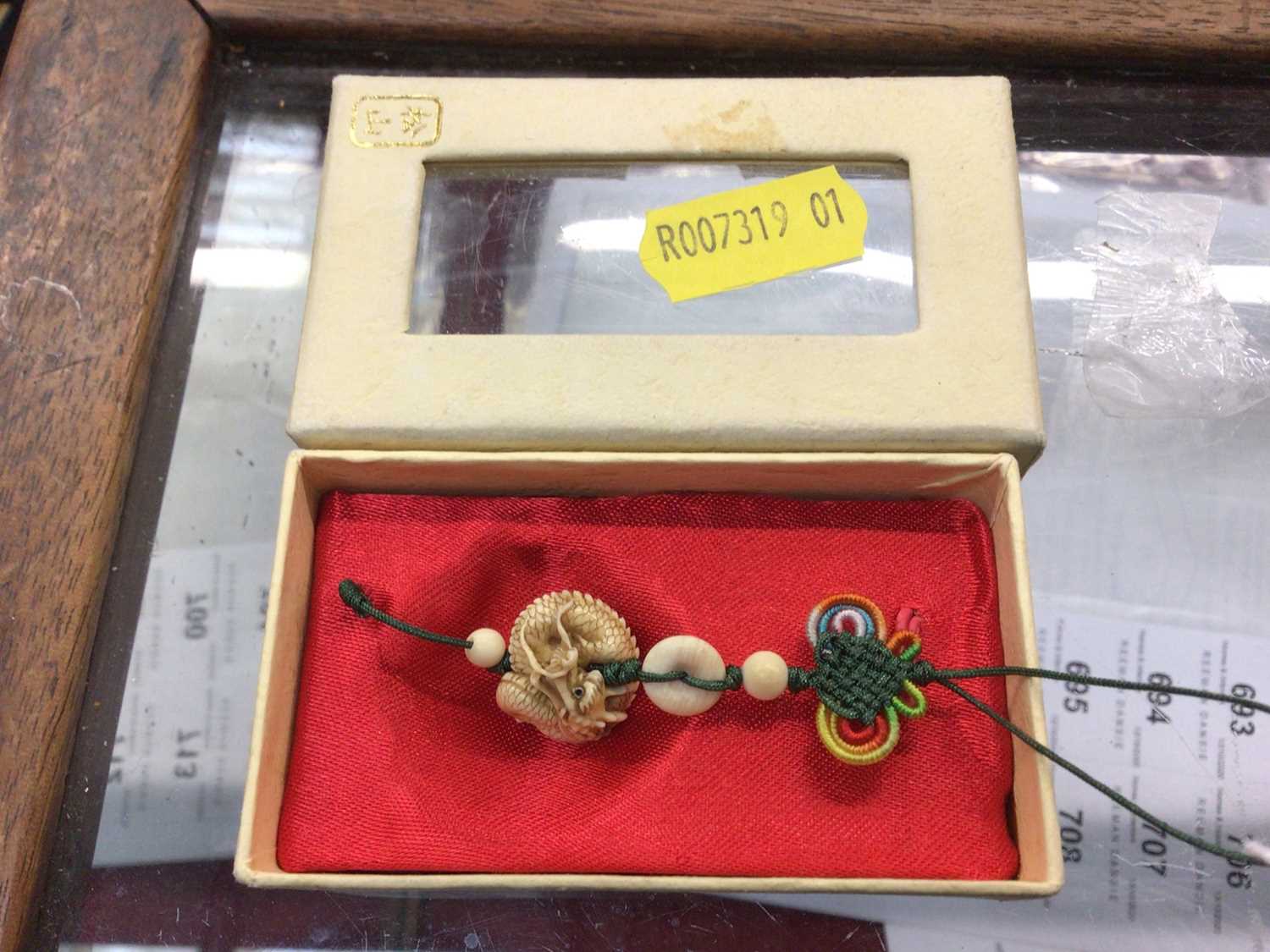 Lot 686 - Small Chinese carved ivory dragon pendant in original box