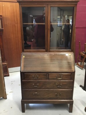 Lot 854 - Georgian -style mahogany bureau bookcase with two glazed doors above , fall flap and four drawers below on reeded feet