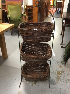 Lot 867 - Three wicker baskets housed in a metal stand, ideal for vegetables