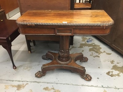 Lot 863 - Regency rosewood card table with fold over top and baize lined interior on inverted tulip column,quatrefoil platform raised on paw feet 92 cm wide