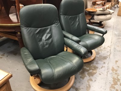 Lot 962 - Pair of Stressless green leather revolving and reclining armchairs