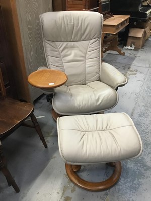 Lot 961 - Stressless cream leather revolving and reclining armchair and matching footstool