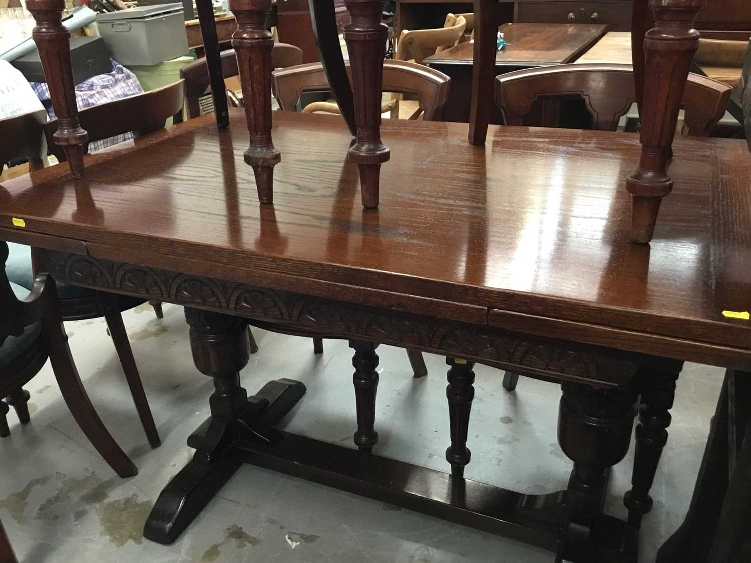 Lot 901 - Carved oak drawer leaf dining table on end standards