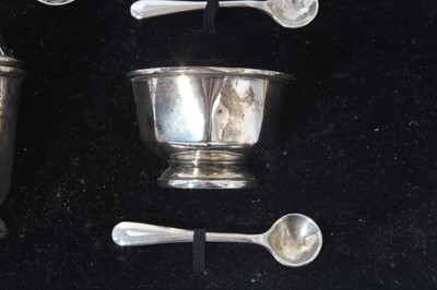 Lot 80 - George V silver six piece cruet set comprising two salt cellars, two pepperettes, two mustard pots (Birmingham 1930), together with four silver salt and mustard spoons